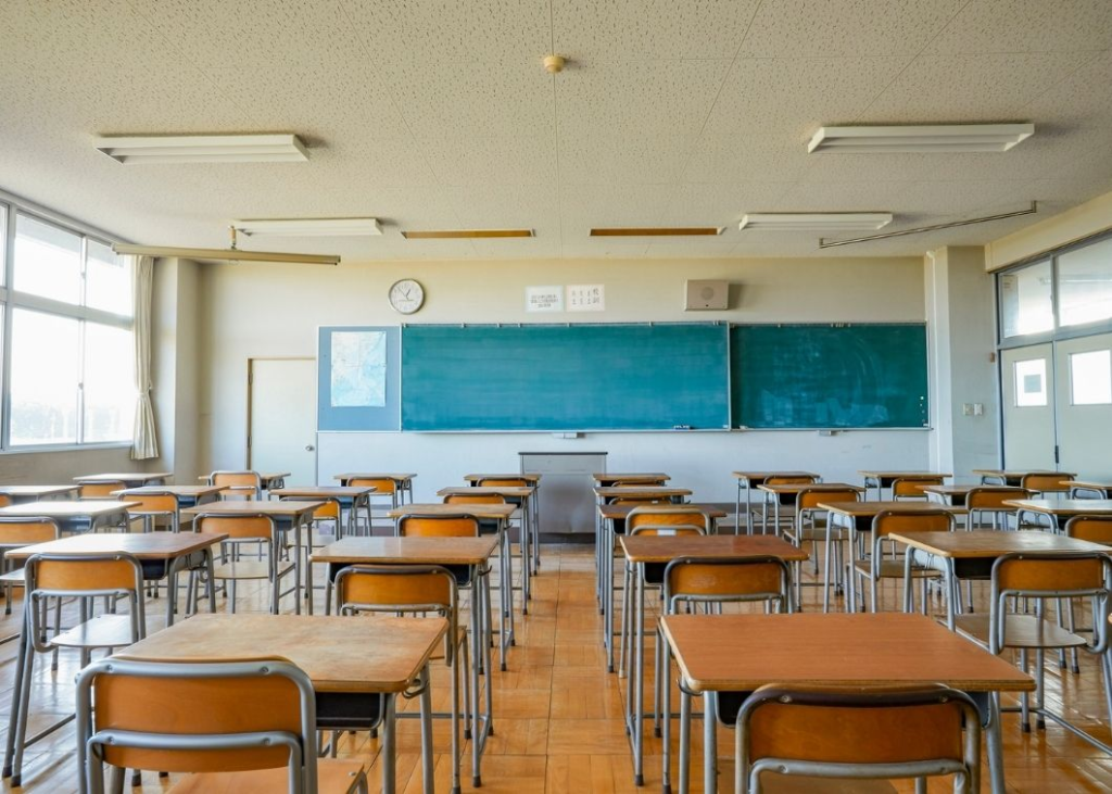 Empty classroom with desks and chalkboard