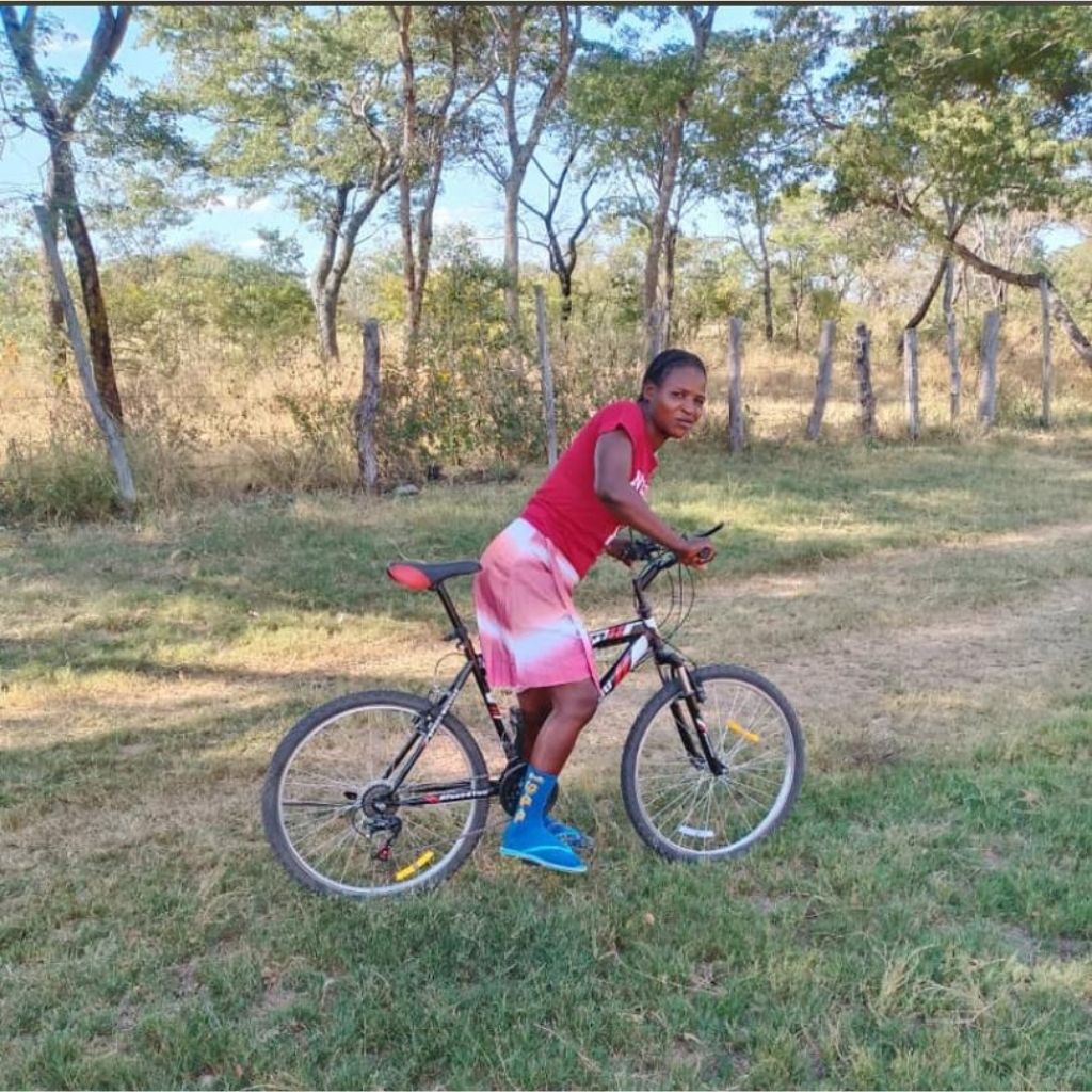 Young woman on bicycle in rural Zimbabwe