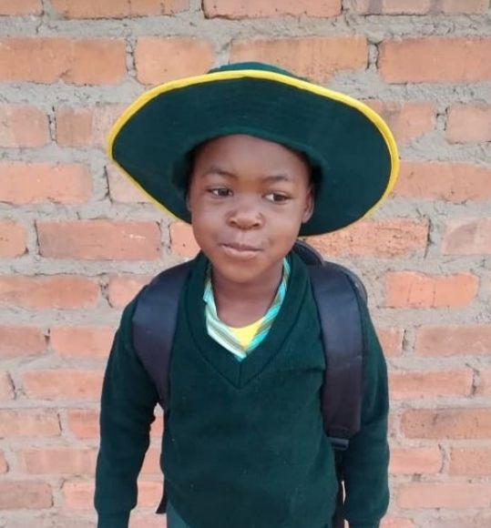 Shaylene aged 5 in Zimbabwean school uniform
