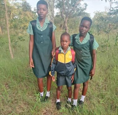 Three children in school uniforms rural Zimbabwe