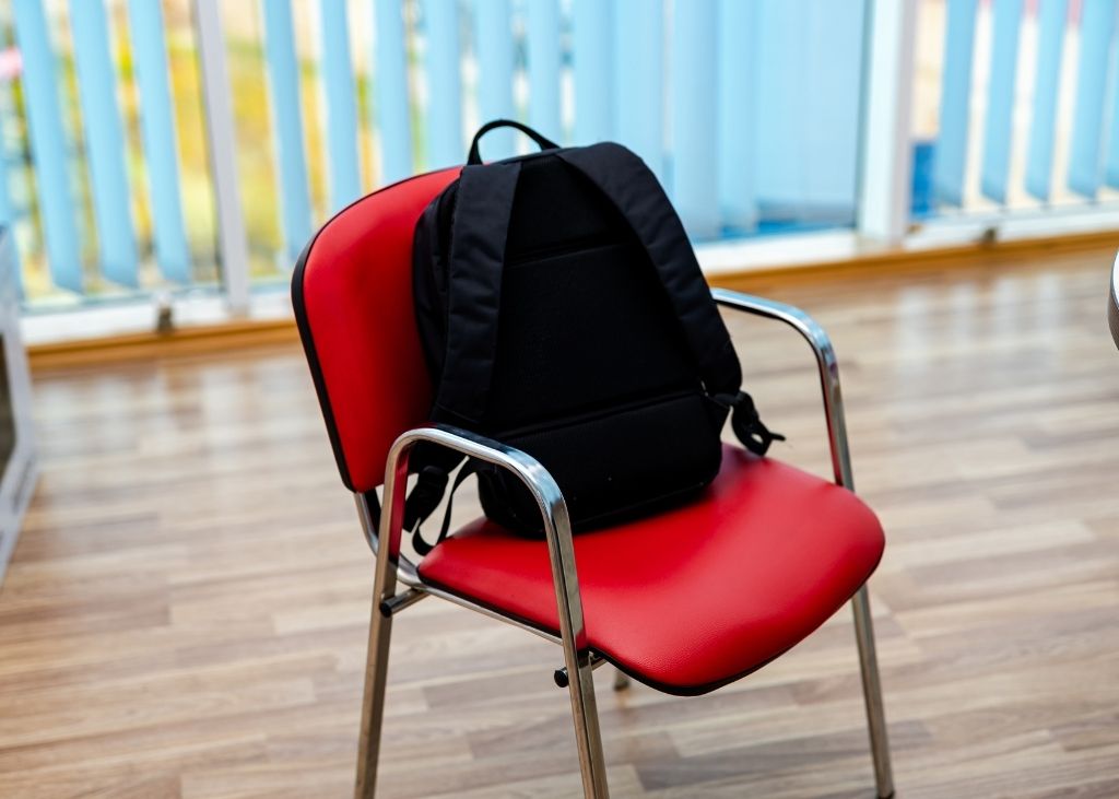 School backpack on red chair in classroom